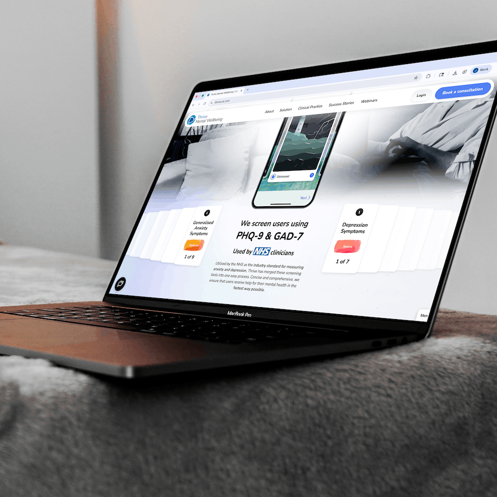 A mockup of a website design for a logistics recruitment company based in the United States. A Macbook computer sitting on a grey speckled table, showing off the landing page of a beautiful dark themed website.