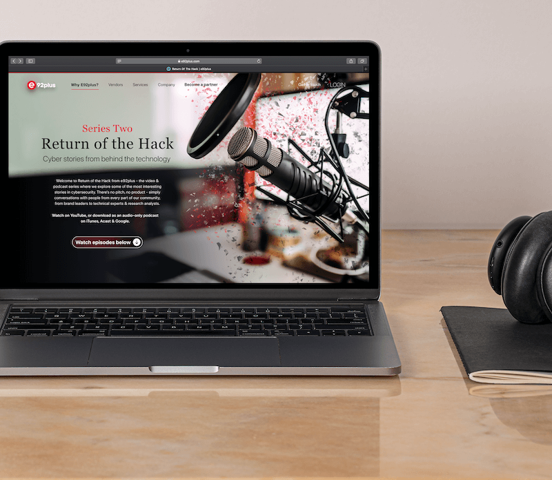 A mockup of a website design for a logistics recruitment company based in the United States. A Macbook computer sitting on a grey speckled table, showing off the landing page of a beautiful dark themed website.